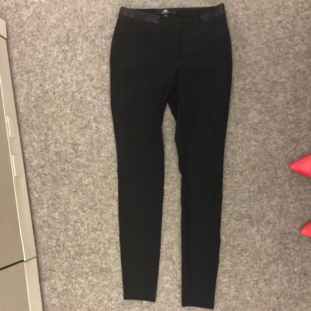 Sleek black skinny fit pants with faux leather waist and back pocket detail